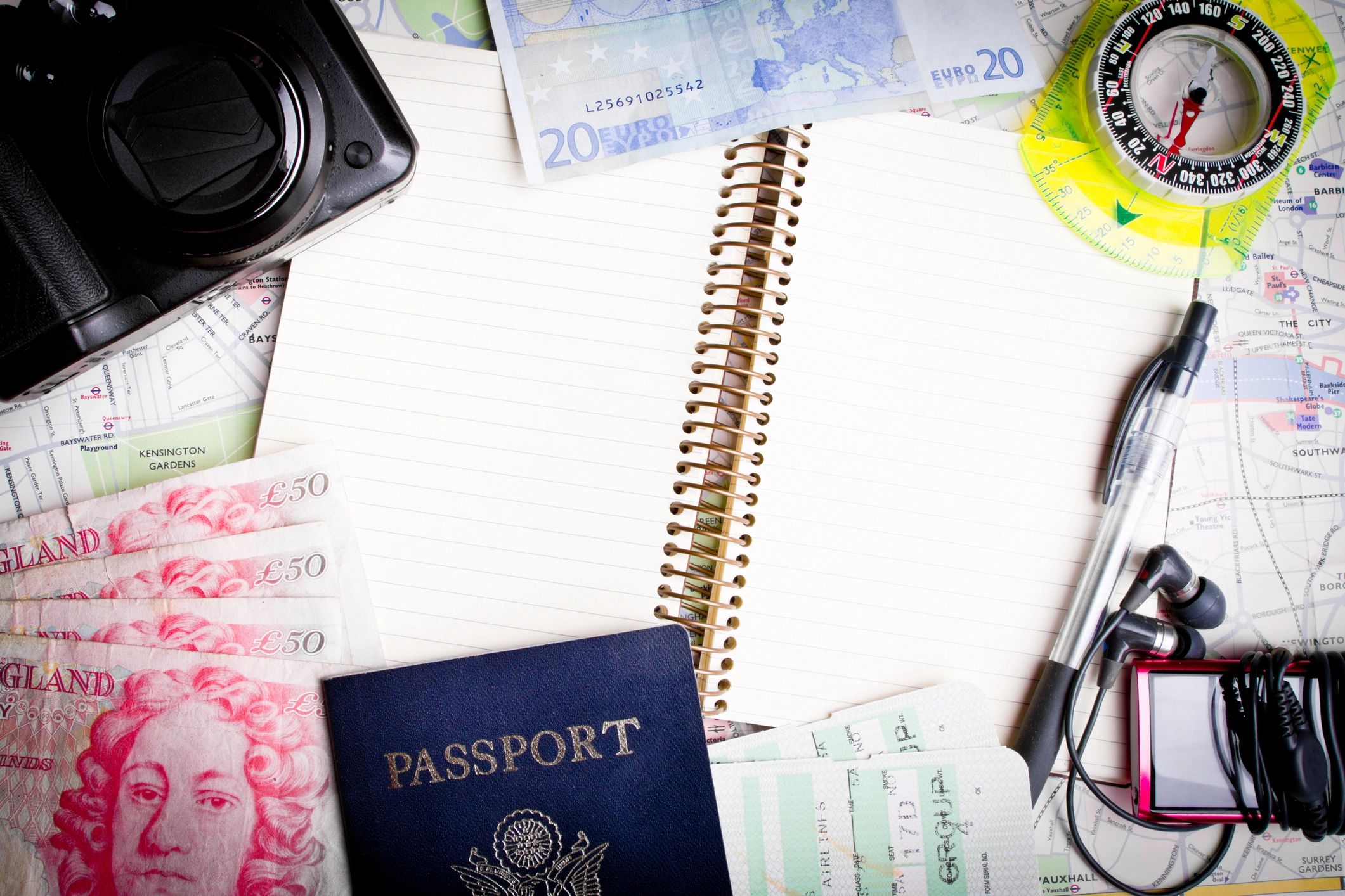 Travel-themed flat lay with notebook and compass