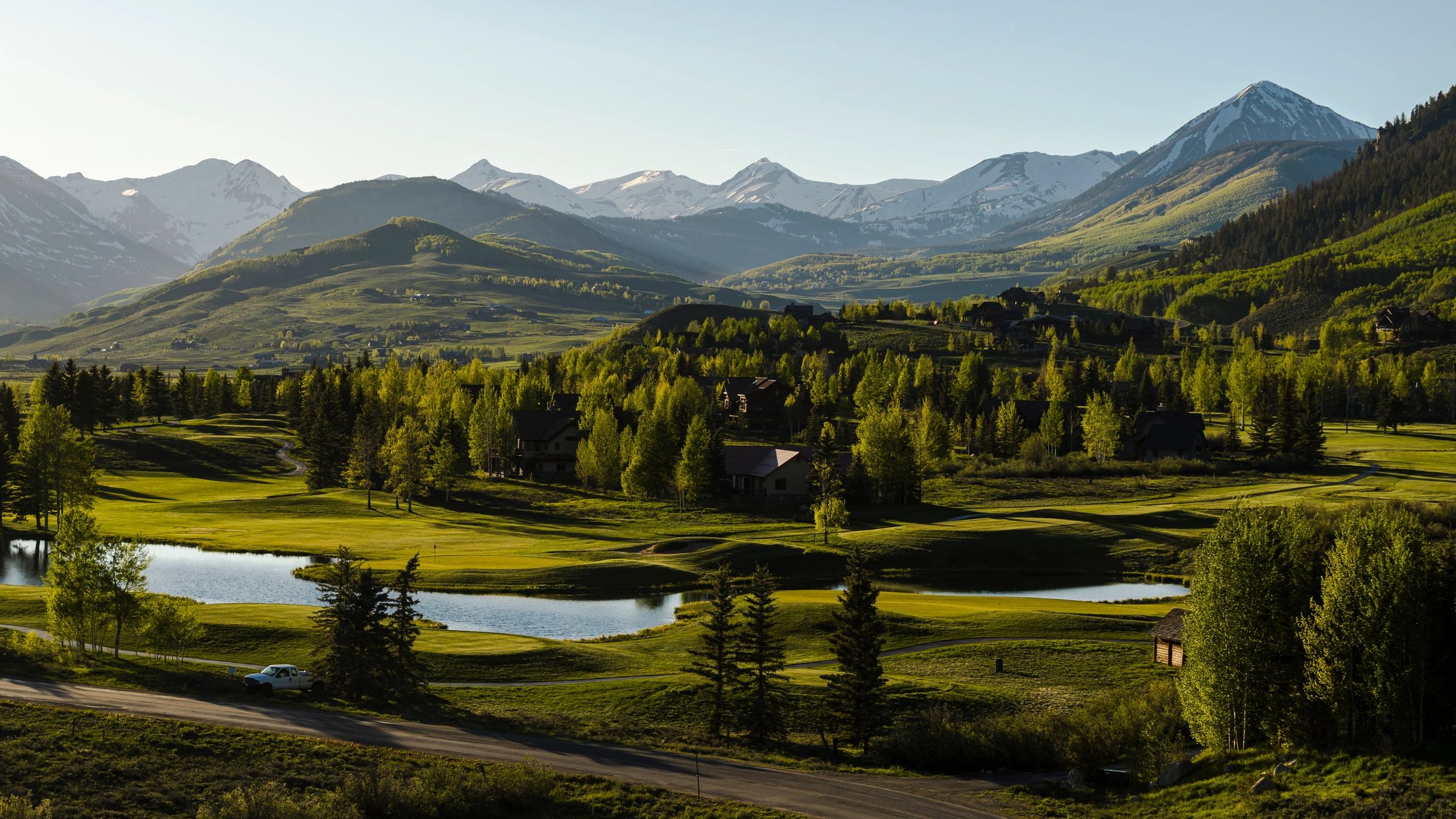 Evening mountain valley in Colorado with ponds and distant peaks