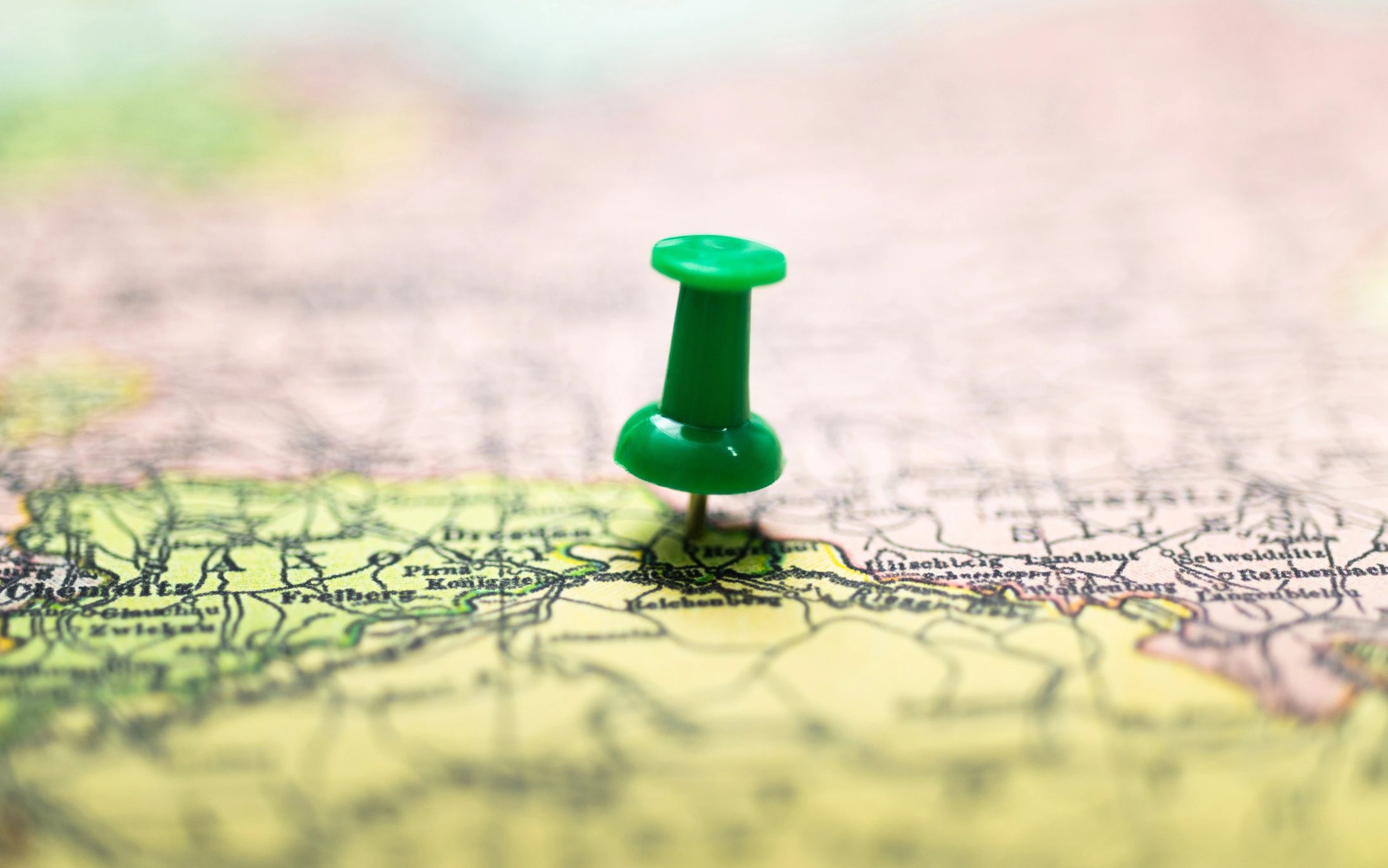 Red pushpin on a vintage map