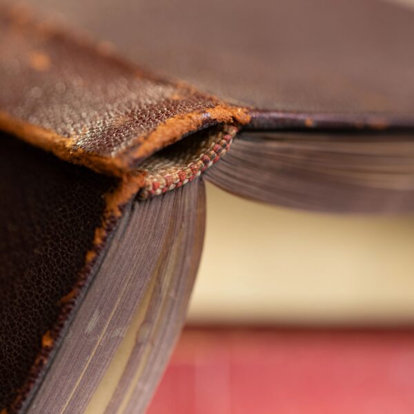 Close-up of an old, worn leather-bound book.