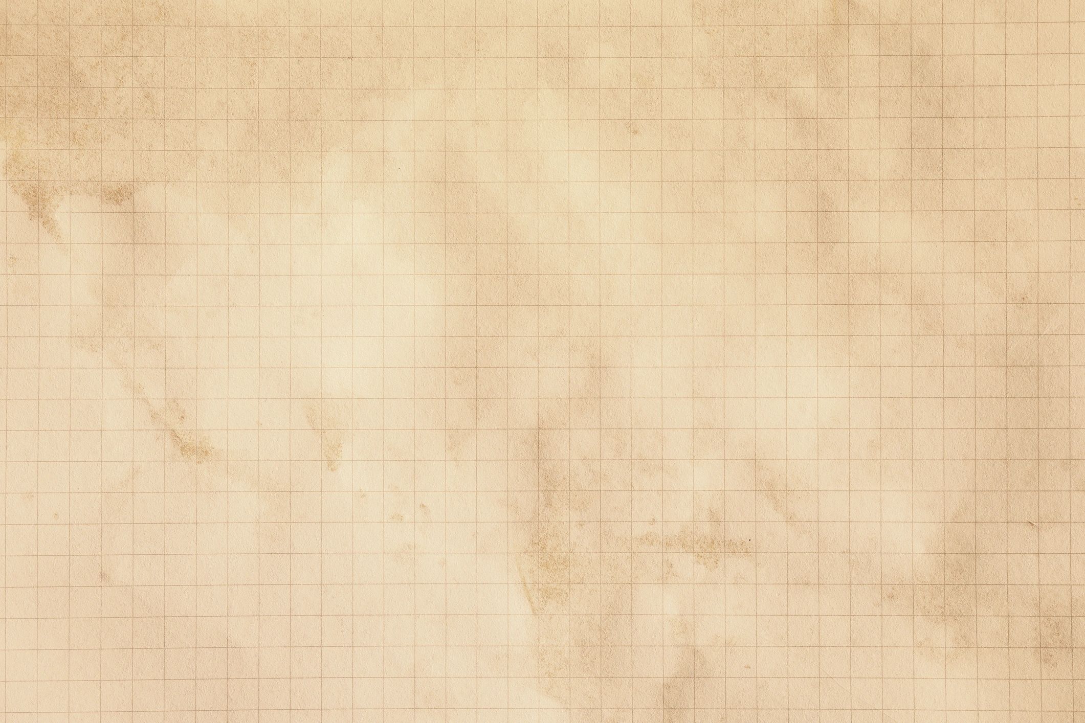 Old yellowed grid paper with brown stains