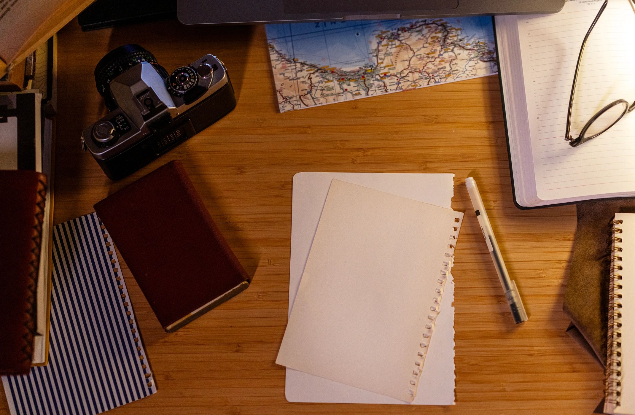 Creative travel workspace with vintage camera and map